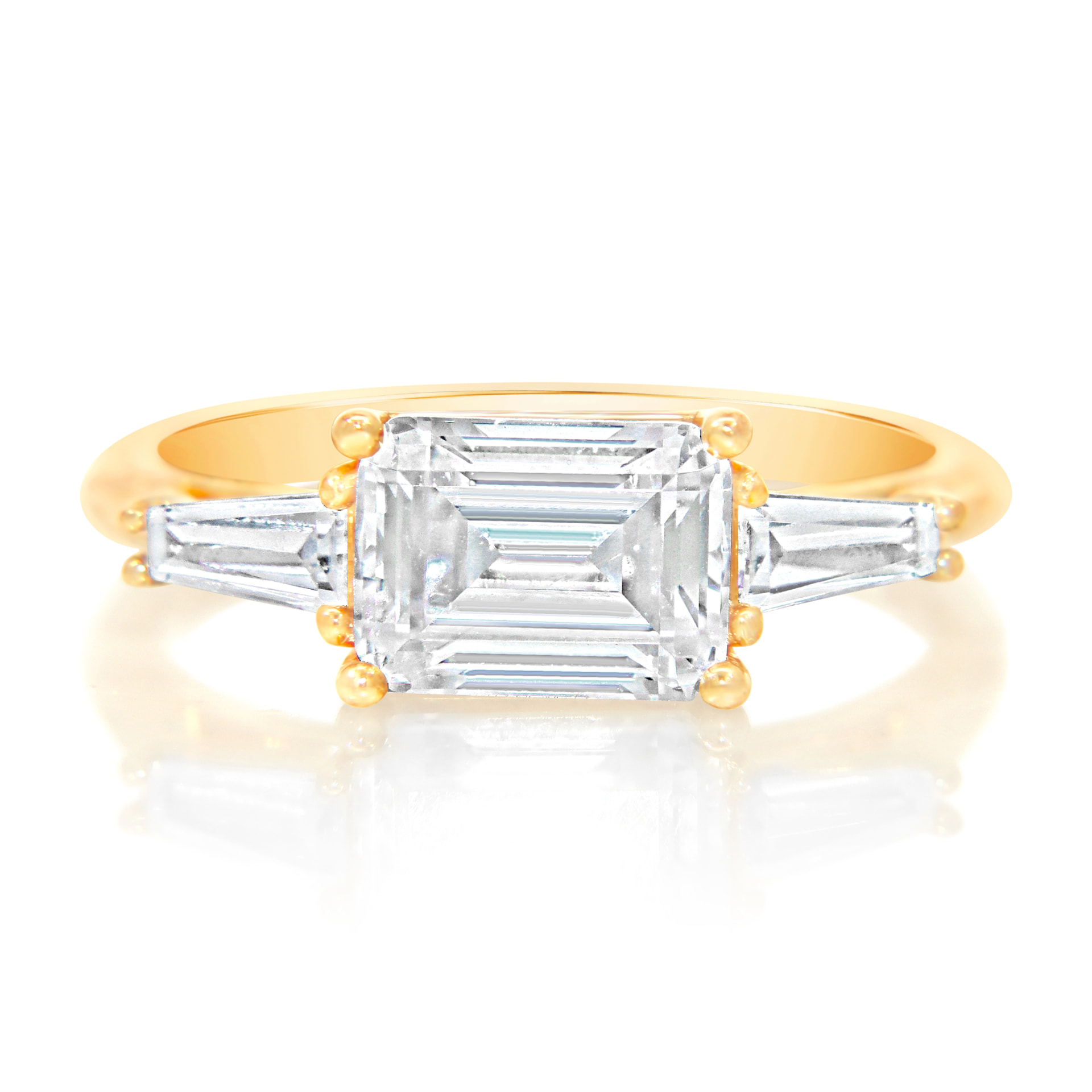 East-west emerald cut ring with tapered baguettes, front view