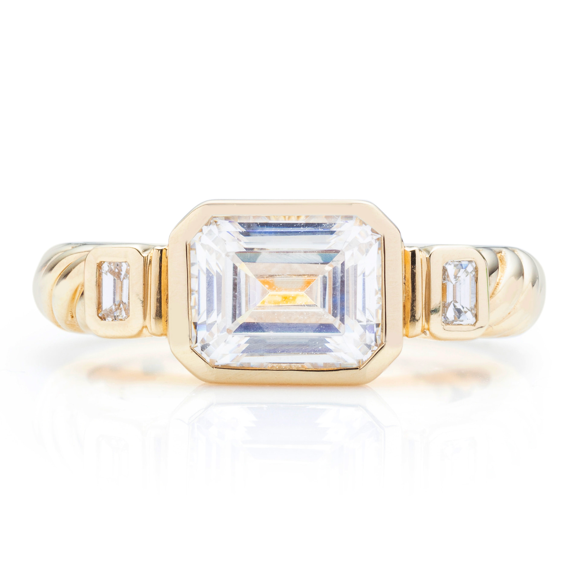 East-west emerald cut bezel ring with cable band, front view