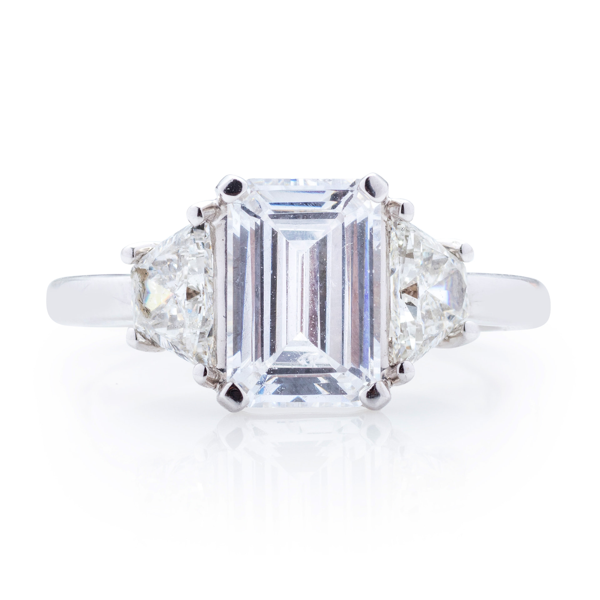Emerald cut three-stone ring with trapezoid side stones, front view