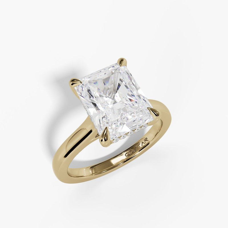 Radiant yellow gold hidden halo solitaire, three-quarter view